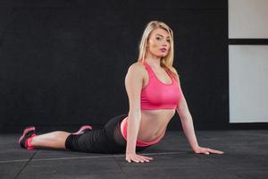 Gorgeous blonde in the audience doing various stretching fitness photo