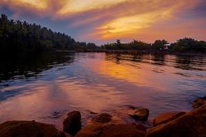 Beautiful calm coastline landscape at sunrise with rocks photo