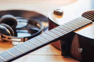 Classical guitar with headphones on a wooden background photo