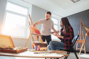 Group of students painting at art lessons photo