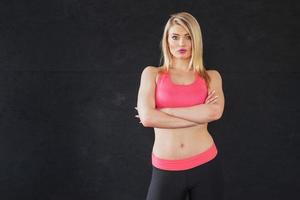 Sexy girl in sportswear with a smile posing for the camera in a sports hall photo