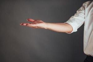 Young businessman showing empty hands, ready to fill with your design photo