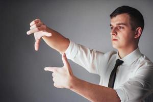 Young businessman showing empty hands, ready to fill with your design photo