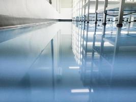 a cable under rack legs at sea blue epoxy floor.Industrial epoxy floor photo