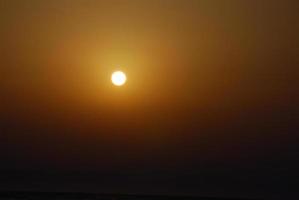 hazy Sun at sunrise in Egypt photo