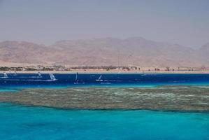 colorful reef near the city of the beach near the sea for diving photo