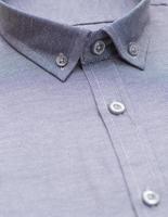 cotton shirt with a focus on the collar and button, closeup photo