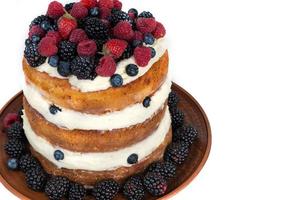 Victoria sponge cake with whipped cream and berries on top photo