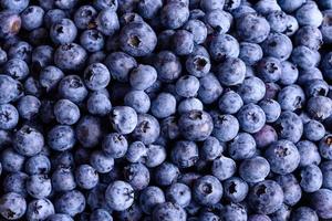 Beautiful fresh delicious blueberries on a black plate photo