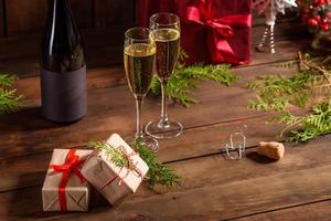 Christmas holiday table with glasses and a bottle of wine of champagne photo