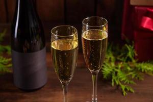 Christmas holiday table with glasses and a bottle of wine of champagne photo