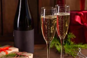 Christmas holiday table with glasses and a bottle of wine of champagne photo