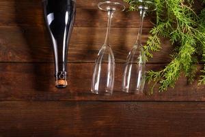 Christmas holiday table with glasses and a bottle of wine of champagne photo