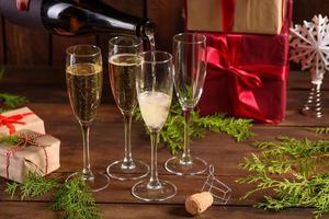 Christmas holiday table with glasses and a bottle of wine of champagne photo