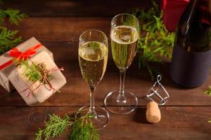 Christmas holiday table with glasses and a bottle of wine of champagne photo