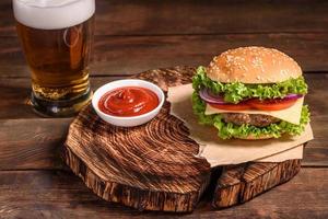 Delicious fresh juicy burger with beef cutlet, cheese, tomatoes and onions