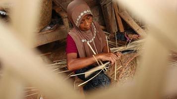bamboo basket craftswoman while doing his work in a place, Batang, Jawa Tengah, Indonesia, May 26, 2019