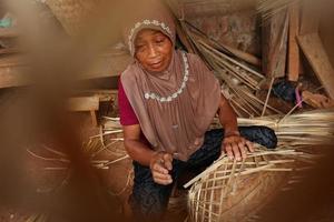 bamboo basket craftswoman while doing his work in a place, Batang, Jawa Tengah, Indonesia, May 26, 2019