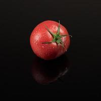 tomatoes on a black background photo