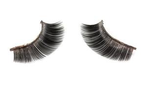 Use of  artificial eyelashes macro Isolated on white background photo