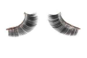 Use of  artificial eyelashes macro Isolated on white background photo