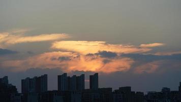 The beautiful sunset view with the silhouette and colorful clouds sky in the city photo