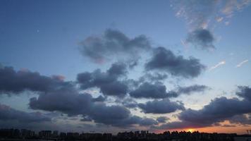 la hermosa vista de la puesta de sol con la silueta y el cielo de nubes coloridas en la ciudad foto