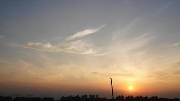 The beautiful sunset view with the silhouette and colorful clouds sky in the city photo