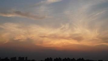 la hermosa vista de la puesta de sol con la silueta y el cielo de nubes coloridas en la ciudad foto