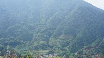 The beautiful mountains landscapes with the green forest and little village as background in the countryside of the China photo
