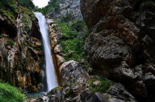 high waterfall in the mountains photo