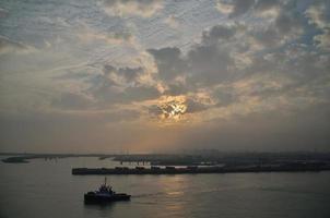 harbor with sun and clouds photo