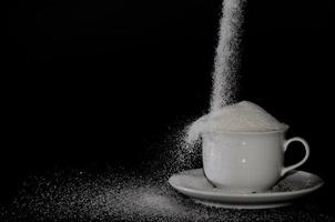 white cup full of sugar photo