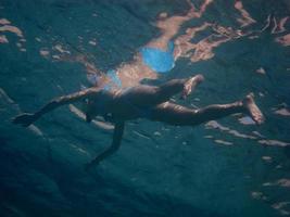 woman in a bikini swimming in the sea photo