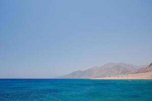 blue sea with mountain photo