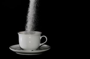 sugar trickles into cup photo