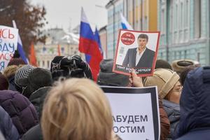 Moscow, Russia - February 24, 2019.People carrying the opposition magazine called New Times with Boris Nemtsov portrait photo