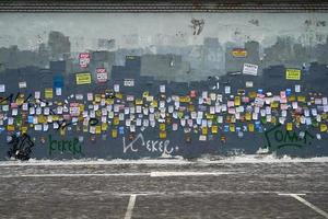 Moscow, Russia - December 08, 2018. Paper advertisements on the shabby wall in Moscow photo