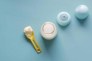 top view of baby milk powder and spoon on tile background. photo