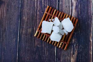 sugar candy on a wooden board on black background photo