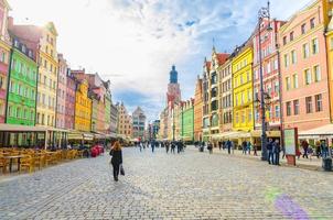 Wroclaw, Poland, May 7, 2019 old town historical city centre, colorful buildings with multicolored facade, St. Elizabeth Minor Basilica Garrison catholic Church on cobblestone Rynek Market Square