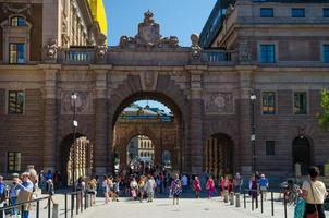 Sweden, Stockholm, May 30, 2018 People walk through Courtyard between arches of Parliament House Riksdag