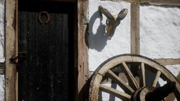 old wood wheel and black door at white house video
