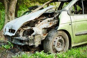 Burned car exterior, vehicle fire due to short circuit, arson, fire damaged motor vehicle, car fire photo