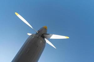 Airplane propeller of military aircraft, copy space, Blue sky background. photo