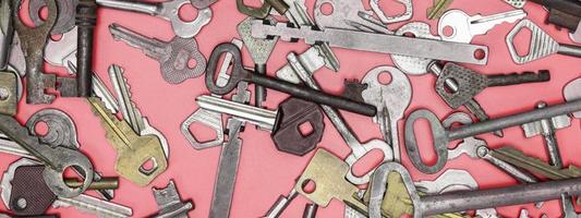 Keys set on pink background. Door lock keys and safes for proper photo