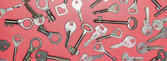 Keys set on pink background. Door lock keys and safes for proper photo