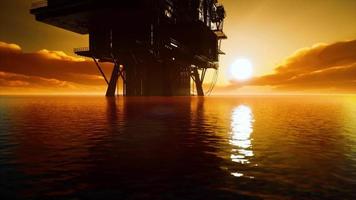 Offshore oil rig platform in sunset or sunrise time