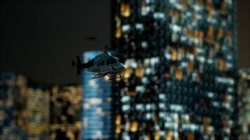 slow motion helicopter near skyscrapers at night