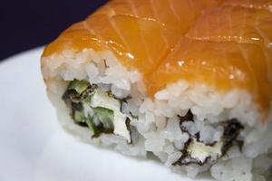Delicious Philadelphia and California Sushi with Salmon and Masago Caviar on a Purple Background, Panoramic Shot. photo